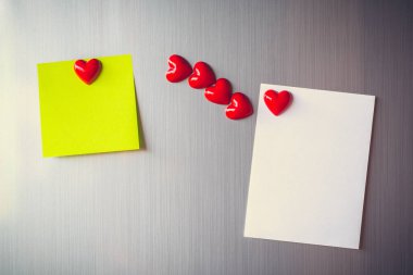 Vintage picture tone of Empty paper sheet on refrigerator door. Note paper with magnetic heart. Valentine send text love message.
