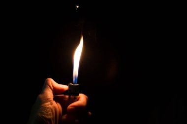 abstract Motion Hand with lighter igniting sparks on dark background