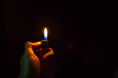 abstract Motion Hand with lighter igniting sparks on dark background