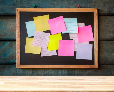 Wooden plank table for graphic stand product, interior design or montage display your product with green blank texture blackboard for background. education concept.