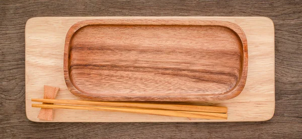 Empty sushi bamboo tray board on wood table white background. Bamboo products that have been processed into trays for use in the kitchen. Top view of plank wood for graphic stand design product.