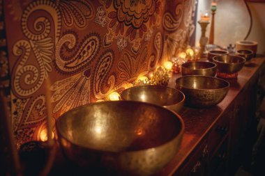 beautiful tibetan bowl on a wooden shelf, ceremonial space