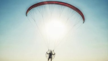Paraglider in the air, beautiful blue sky in the background. Loop Animation