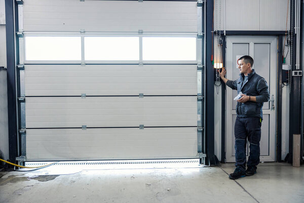Mechanic Pressing Button Opening Garage Door Car Workshop Stock Image