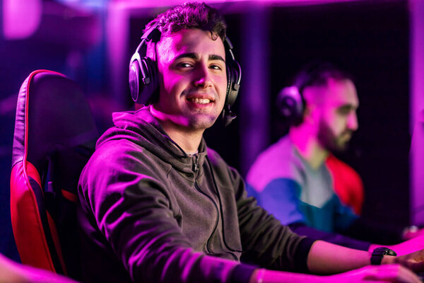 A happy video game champion playing video game at gaming room and smiling at the camera. — Stock Image Happy Video Game Champion Playing Video Game Gaming Room Smiling Royalty Free Stock Photos