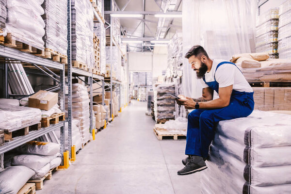 Storage Worker Getting Orders Online Tablet While Sitting Sacks Flour Stock Photo