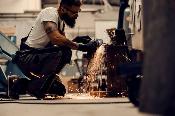 A metallurgy worker using grinder to process metal parts in facility. — Stock Image Metallurgy Worker Using Grinder Process Metal Parts Facility Royalty Free Stock Photos