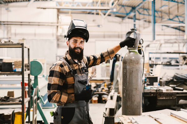 A heavy industry worker posing with welding machine in facility. — Stock Image Heavy Industry Worker Posing Welding Machine Facility Royalty Free Stock Images