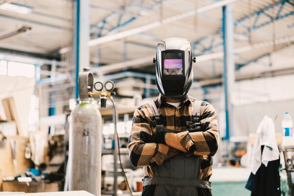A heavy industry worker with welding mask on face proudly standing in facility. — Stock Image Heavy Industry Worker Welding Mask Face Proudly Standing Facility Royalty Free Stock Images