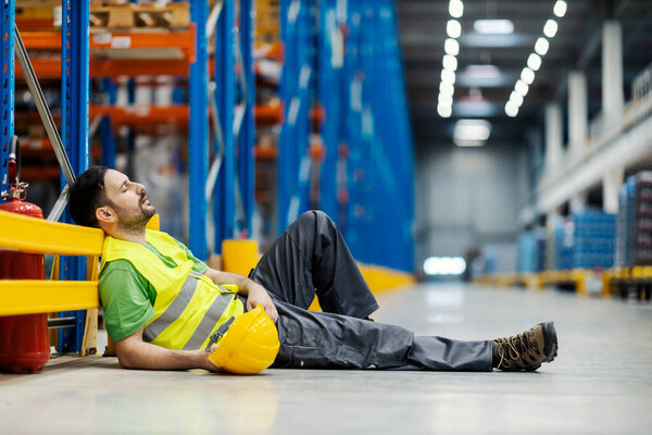 Exhausted storage worker sleeping and snoring on the floor on work hours. — Stock Image Exhausted Storage Worker Sleeping Snoring Floor Work Hours Stock Photo