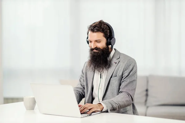 Ein Geschäftsmann Sitzt Hause Mit Kopfhörern Und Arbeitet Laptop — Stockfoto