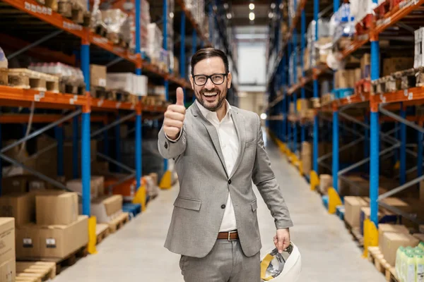 stock image Portrait of a businessman in storage giving thumbs up and approval for shipping.