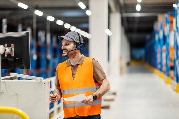 A supervisor looking at the monitor and navigates freight at storage. — Stock Image Supervisor Looking Monitor Navigates Freight Storage Royalty Free Stock Images