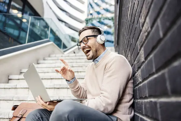 Smiling Urban Man Sits Stairs Street Headphones Having Conference Call Royalty Free Stock Photos