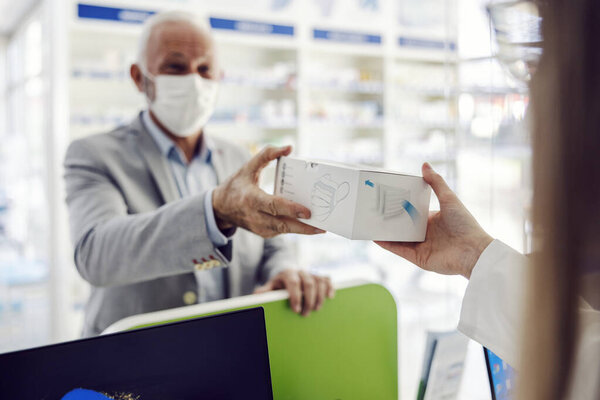 A senior man purchasing face masks at apothecary. — Stock Image Senior Man Purchasing Face Masks Apothecary Stock Picture