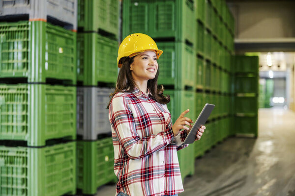 A happy female inspector checking on tablet goods in facility. — Stock Image Happy Female Inspector Checking Tablet Goods Facility Royalty Free Stock Images