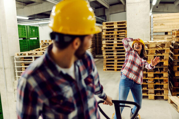 Happy workers having fun at work, pulling forklift and playing a game. — Stock Image Happy Workers Having Fun Work Pulling Forklift Playing Game Stock Picture