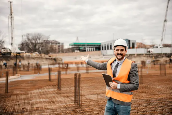 Cheerful Engineer Tablet Hands Showing Construction Site While Smiling Camera — Stock Photo, Image