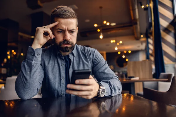 Worried Man Sitting Cafeteria Looking His Phone — Stock Photo, Image