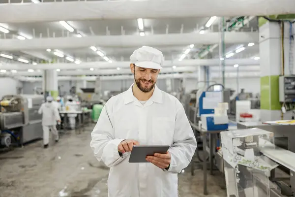 Happy Meat Factory Inspector Using Tablet Checking Meat Production While Stock Photo