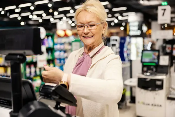 Iloinen Vanha Nainen Maksaa Älykkäällä Katsella Itsepalvelukassalla Supermarketissa — kuvapankkivalokuva