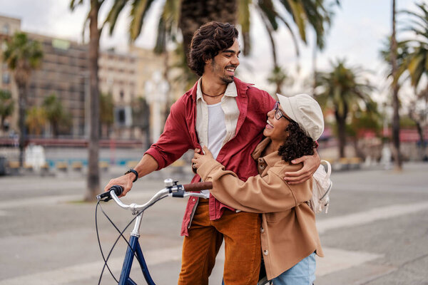 A happy romantic travelers are embracing on the city street on a bike during their vacation in Spain. — Stock Image Happy Romantic Travelers Embracing City Street Bike Vacation Spain Royalty Free Stock Images
