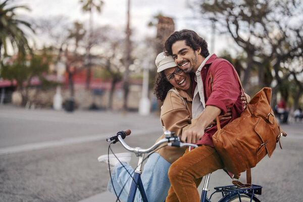 A couple in love is standing with bike on the street and hugging during their visit to Europe. — Stock Image Couple Love Standing Bike Street Hugging Visit Europe Stock Picture