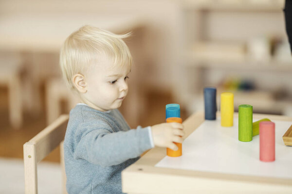 Portrait of a kindergartener playing with educational toys and learning colors. — Stock Image Portrait Kindergartener Playing Educational Toys Learning Colors Stock Photo