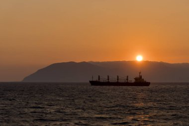 Kargo gemisi denizde. Toptan taşıyıcı. Gün batımında kuru kargo gemisi. Altın saat.