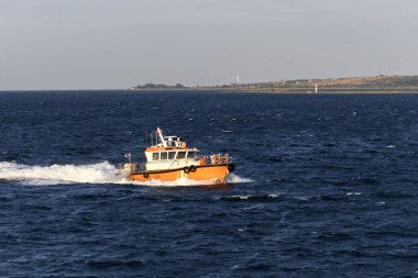 Pilot boat and cargo vessel at sea. Pilot embarkation. Pilotage.