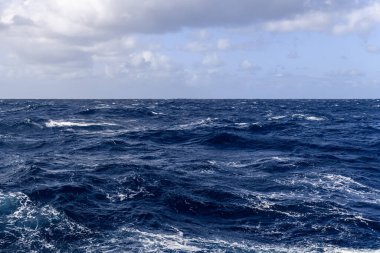 Güzel deniz manzarası. Dalgalar, bulutlar ve güzel ışıklandırmalı gökyüzü. Fırtınalı deniz, kötü hava. Gale. Dalgalı deniz. Beaufort ölçeği 6.