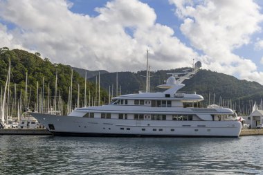 Luxury super yacht moored alongside in marina. Forward view. Motor yacht. Yachting concept.