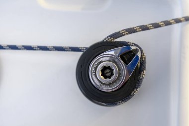 Yacht winch with rope on sailing boat. Top view. Yachting concept.