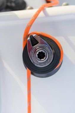 Yacht winch with orange rope on sailing boat. Top view. Yachting concept.