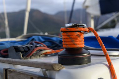 Yacht winch with orange rope on sailing boat. Yachting concept.