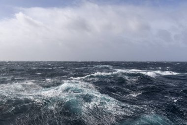 Güzel deniz manzarası. Dalgalar, bulutlar ve güzel ışıklandırmalı gökyüzü. Fırtınalı deniz, kötü hava. Gale. Dalgalı deniz.
