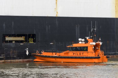 Pilot boat and cargo vessel at sea. Pilot embarkation. Pilotage.