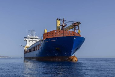 Denizde mavi kuru kargo gemisi. Rüzgar jeneratörlerini demirde taşıyan çok amaçlı bir gemi. Deniz seviyesinden görüntüle. 