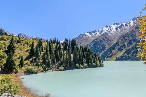 stock image Beautiful mountain lake, forest and mountains. Big Almaty lake in summer time. Mountain landscape in Kazakhstan.