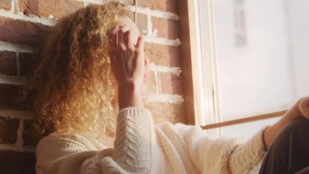 Curly Caucasian Woman Catching Sunlight Window Sill Indoors — Αρχείο Βίντεο