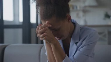 Distressed woman. Businesswoman is stressed and grieving. Slow motion of an African American female feeling upset and desperate inside her home