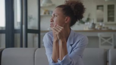 Woman in grief. Businesswoman in despair. African American adult female in blue suit is desperate while facing problems in her business