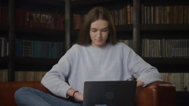Woman having problem on her laptop, caucasian female receiving bad news on computer indoors. Stressed and upset student in emotions