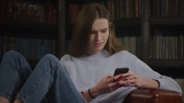 Woman receiving unbelievable news on smartphone. Caucasian female in shock