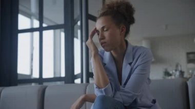 Upset businesswoman, stressed woman low angle portrait indoors in slow motion