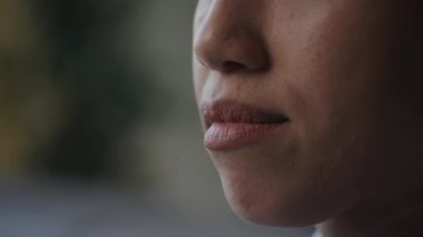 Extreme close up of a woman smile side view shot handheld in slow motion