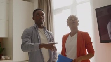 Man talking to real estate manager. Property rent choice discussion - shot handheld in slow motion