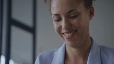 Woman emotions close up, businesswoman texting online with a smile. African American female laughing