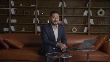 Entrepreneur portrait in office, Businessman looking at camera shot handheld in slow motion