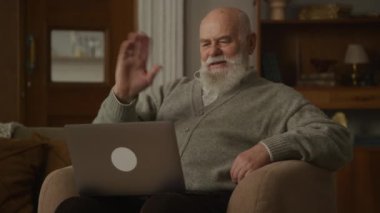 Video 'daki büyükbaba dizüstü bilgisayar kullanıyor, üst düzey adam konferans görüşmesini içeride yapıyor.